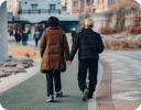 A man and a woman walking on a street.