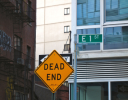 A yellow sign on a pole.